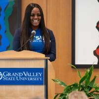 A Thompson scholar speaking at the podium.